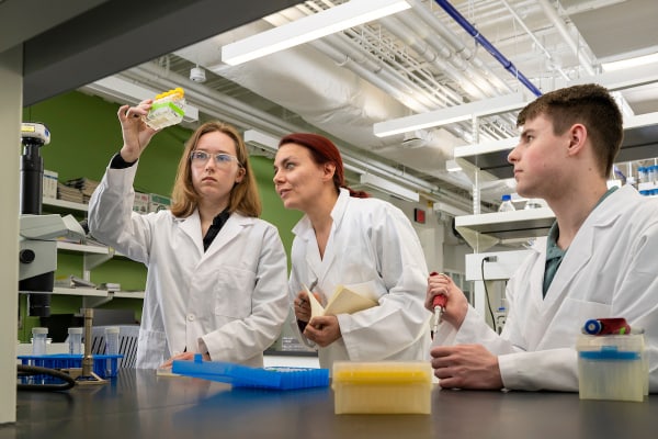 Professor in biology lab with students